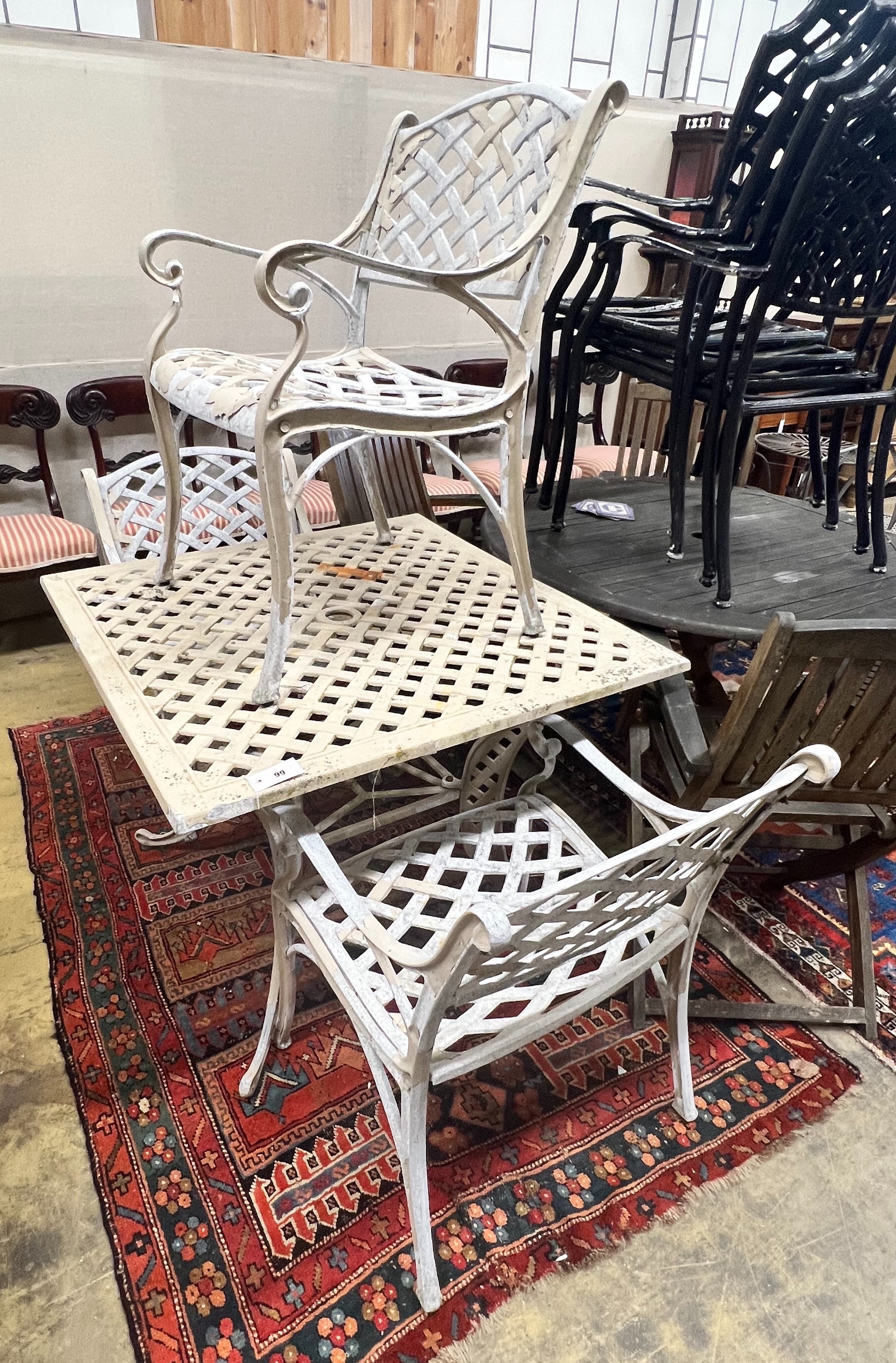 A square painted aluminium garden table and three elbow chairs, table width 91cm height 73cm